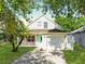 Charming two-story home featuring a well-manicured lawn and a lovely front porch at 5607 Tanagergrove Way, Lithia, FL 33547