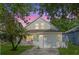 Charming two-story home featuring a well-manicured lawn and a lovely front porch at sunset at 5607 Tanagergrove Way, Lithia, FL 33547