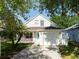 Charming home featuring a well-maintained lawn, inviting front porch with rocking chairs, and an attached two-car garage at 5607 Tanagergrove Way, Lithia, FL 33547