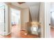 Hallway leading to the stairs with wood-look floors and an open door to a bedroom at 5607 Tanagergrove Way, Lithia, FL 33547