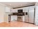 Modern kitchen boasts stainless steel appliances, ample cabinet space, and tile flooring at 5607 Tanagergrove Way, Lithia, FL 33547