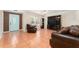 Comfortable living room with a TV, a blue front door, and leather furniture at 5607 Tanagergrove Way, Lithia, FL 33547