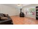 Inviting living room with tile flooring, a ceiling fan, and comfortable leather furniture at 5607 Tanagergrove Way, Lithia, FL 33547