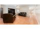 Spacious living room with tile flooring and comfortable leather furniture at 5607 Tanagergrove Way, Lithia, FL 33547