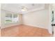 Bright main bedroom with tile floors, a ceiling fan, and a large window at 5607 Tanagergrove Way, Lithia, FL 33547