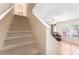 Carpeted stairway and view of the living room, featuring a charming front door at 5607 Tanagergrove Way, Lithia, FL 33547