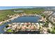 Sweeping aerial shot of a residential area centered around a beautiful lake surrounded by lush greenery at 5818 Cruiser Way, Tampa, FL 33615