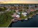 Beautiful waterfront home with sunset view, boat dock, and lush landscaping at 5818 Cruiser Way, Tampa, FL 33615