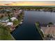 Stunning sunset view of a beautiful waterfront neighborhood with well-maintained homes and boat docks at 5818 Cruiser Way, Tampa, FL 33615