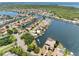 Aerial view of a waterfront community showcasing homes along a waterway with mature landscaping at 5818 Cruiser Way, Tampa, FL 33615