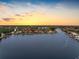 Aerial view of a waterfront home and its dock situated on a serene waterway with beautiful sky at 5818 Cruiser Way, Tampa, FL 33615