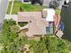 Overhead view of the property showcasing the tile roof, pool, rooftop deck, and waterfront location at 5818 Cruiser Way, Tampa, FL 33615