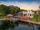 Aerial view of the backyard of a waterfront home with a boat, dock, and gazebo at 5818 Cruiser Way, Tampa, FL 33615
