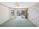 Pool view bedroom with floral accents, green carpet, and sliding glass doors to the outdoor area at 5818 Cruiser Way, Tampa, FL 33615