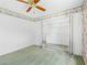 Bright bedroom featuring green carpet, mirrored closet, and a ceiling fan at 5818 Cruiser Way, Tampa, FL 33615