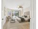 Bright bedroom with neutral tones, a ceiling fan, and sliding glass doors to a screened patio and pool at 5818 Cruiser Way, Tampa, FL 33615