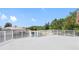 An open-air concrete deck surrounded by white railings overlooking a waterfront view and lush trees at 5818 Cruiser Way, Tampa, FL 33615