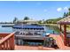 Waterfront dock with a covered boat lift and clear views of the neighborhood at 5818 Cruiser Way, Tampa, FL 33615