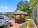 Waterfront property featuring a private dock with a gazebo, seating and boat lift at 5818 Cruiser Way, Tampa, FL 33615