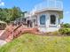 Charming home exterior features a wooden deck with spiral staircase and lush landscaping at 5818 Cruiser Way, Tampa, FL 33615