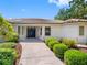 Inviting home entrance featuring a paved walkway leading to a double-door entry and well-maintained landscaping at 5818 Cruiser Way, Tampa, FL 33615