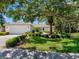 Charming single-story home with a well-manicured lawn, mature trees, and a two-car garage at 5818 Cruiser Way, Tampa, FL 33615