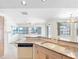 An open kitchen with granite countertops, white cabinetry, and views of the water at 5818 Cruiser Way, Tampa, FL 33615