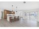 Modern kitchen with a central island, pendant lighting, and sliding door access to the outdoor pool area at 5818 Cruiser Way, Tampa, FL 33615