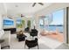 Bright living room featuring water views, spiral staircase to rooftop deck, and modern furnishings at 5818 Cruiser Way, Tampa, FL 33615