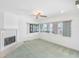 Bright living room with a fireplace and expansive windows overlooking the water at 5818 Cruiser Way, Tampa, FL 33615