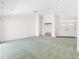 Open living room with neutral carpet, light walls, and a front door with decorative glass panels at 5818 Cruiser Way, Tampa, FL 33615