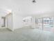 Bright living room with view of the pool; featuring sliding glass doors, carpeted floor, and neutral wall paint at 5818 Cruiser Way, Tampa, FL 33615