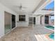 Spacious outdoor patio with travertine floors and a pool, ideal for entertaining and relaxation at 5818 Cruiser Way, Tampa, FL 33615