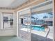 Outdoor patio and pool area seen through sliding glass doors with stone pavers and a relaxing waterfront view at 5818 Cruiser Way, Tampa, FL 33615