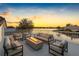 Stylish rooftop deck with comfortable seating, a fire pit, and stunning views of the water and sunset at 5818 Cruiser Way, Tampa, FL 33615