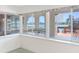 Sunroom with large windows showcasing waterfront views, a built-in seat, and a door to the deck at 5818 Cruiser Way, Tampa, FL 33615