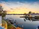 Peaceful waterfront with boat dock, captured at sunset, showcasing the natural beauty of the property at 5818 Cruiser Way, Tampa, FL 33615