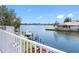 Scenic view of waterfront property features lush greenery and a private boat dock and boat at 5818 Cruiser Way, Tampa, FL 33615