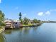 Picturesque waterfront homes featuring private docks and beautiful water views under a clear blue sky at 5818 Cruiser Way, Tampa, FL 33615