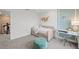 Comfortable bedroom with daybed, white desk, and a decorative butterfly wall art at 5949 Bluestar Ct, Lakewood Ranch, FL 34211