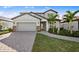 Charming two-story home featuring a manicured lawn and inviting entryway at 5949 Bluestar Ct, Lakewood Ranch, FL 34211