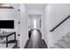 Hallway with view of office, stairs, and door to the outside at 5949 Bluestar Ct, Lakewood Ranch, FL 34211