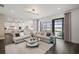 Open-concept living area with a large sectional sofa and sliding glass doors to the outdoor living space at 5949 Bluestar Ct, Lakewood Ranch, FL 34211
