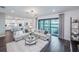 Modern living space with an open floor plan and access to the outdoor living area with pool and lake views at 5949 Bluestar Ct, Lakewood Ranch, FL 34211