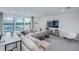 Bright upstairs living room featuring large windows with water views, a sectional, and white walls at 5949 Bluestar Ct, Lakewood Ranch, FL 34211