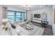 Spacious living room with plush sectional sofa, modern decor, and view of outdoor living space at 5949 Bluestar Ct, Lakewood Ranch, FL 34211