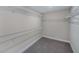 Empty walk-in closet with wire shelving and gray carpet at 5949 Bluestar Ct, Lakewood Ranch, FL 34211