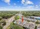 Aerial view of home highlighting neighborhood, lush greenery, and nearby streets at 612 Ozona Village Dr, Palm Harbor, FL 34683
