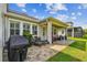 Spacious backyard featuring covered patio with pavers, outdoor seating and room for grilling at 612 Ozona Village Dr, Palm Harbor, FL 34683