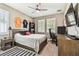 Comfortable bedroom featuring neutral walls, two windows with shutters, and a ceiling fan at 612 Ozona Village Dr, Palm Harbor, FL 34683